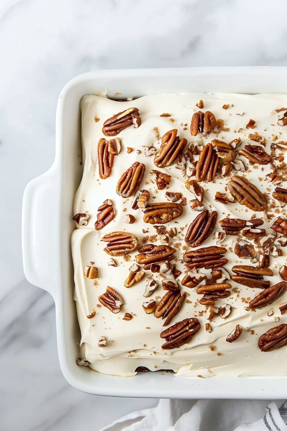 Elvis presley cake with pecan nuts and cream cheese frosting in a 9x13 baking dish