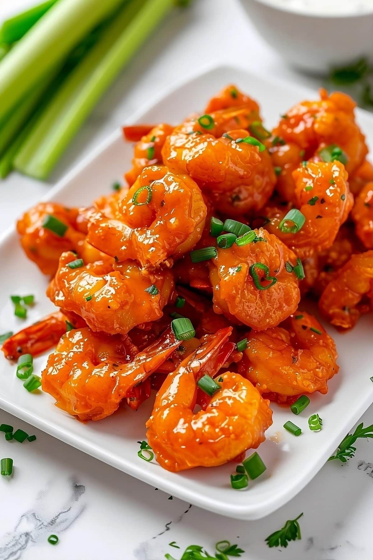 Buffalo shrimp in a square plate.