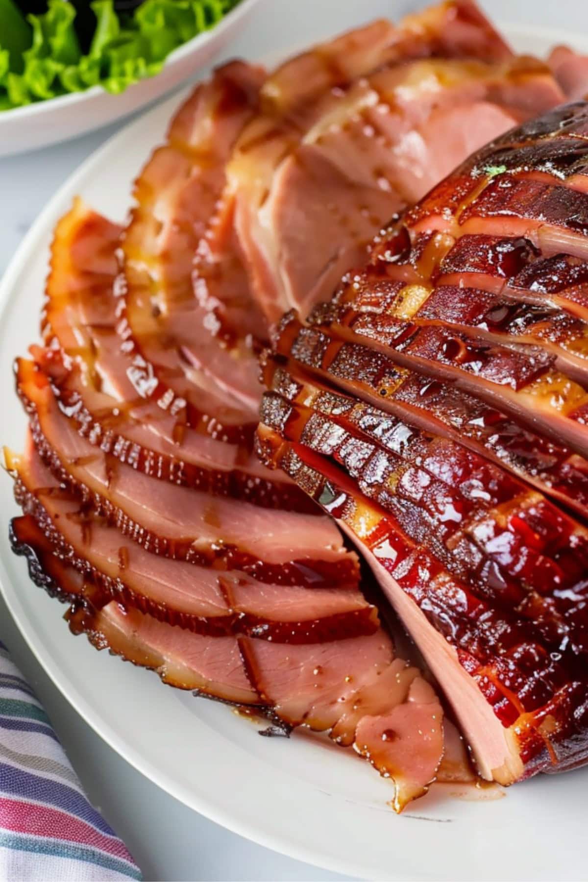 Crispy and tender Coca-Cola glazed ham in a white plate