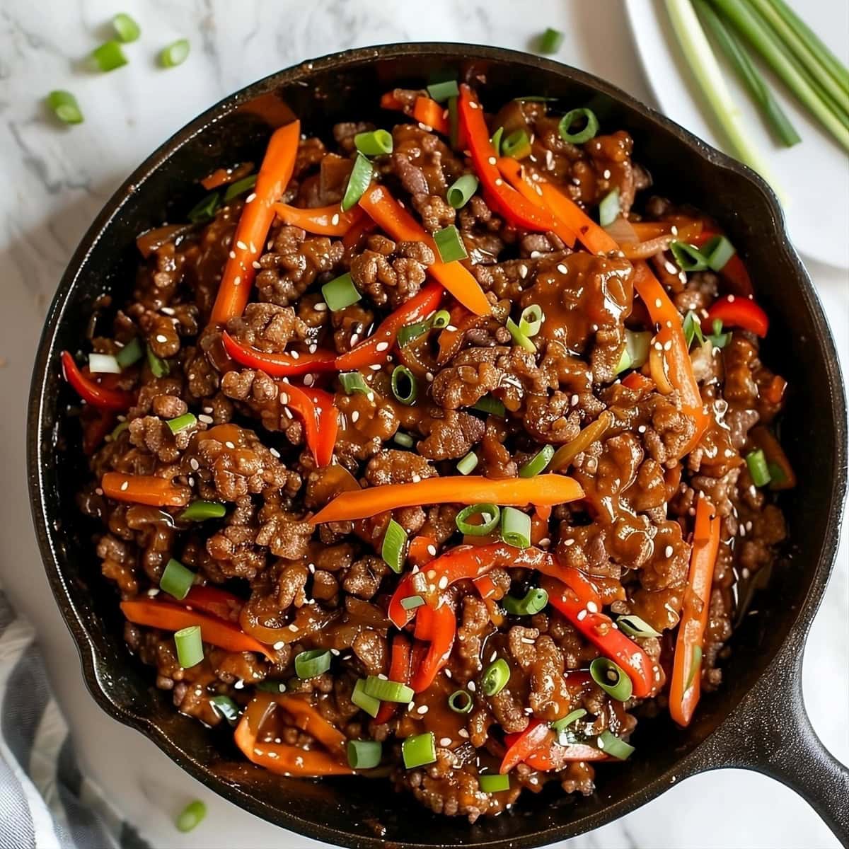 Beef sauteed in a cast iron skillet.