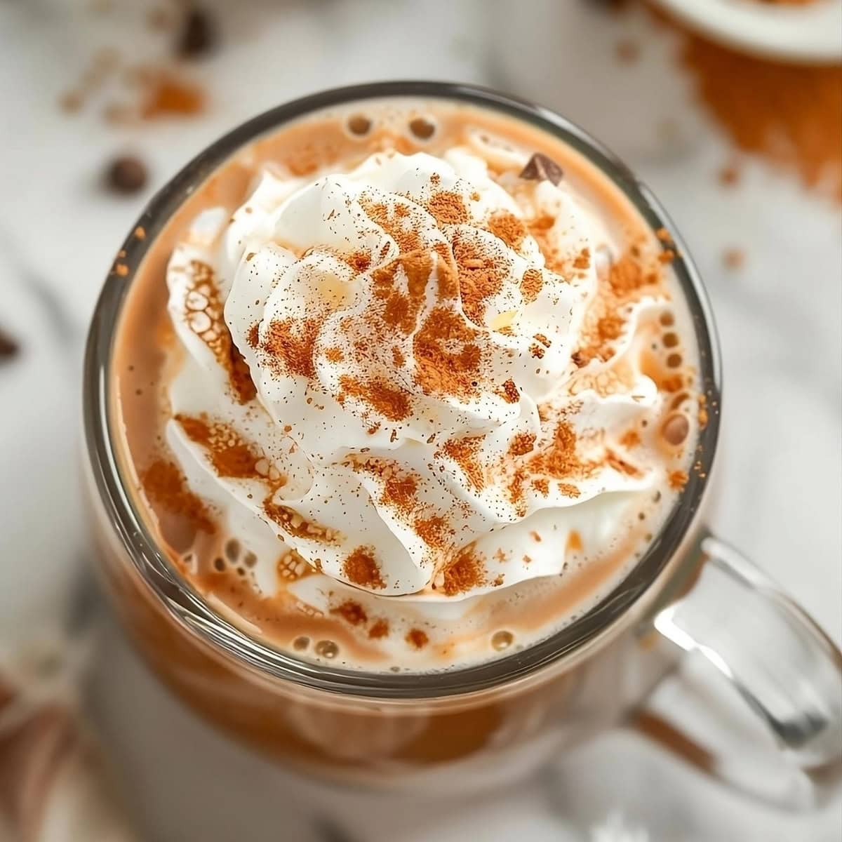 Pumpkin Spice Hot Chocolate in a glass mug top view.