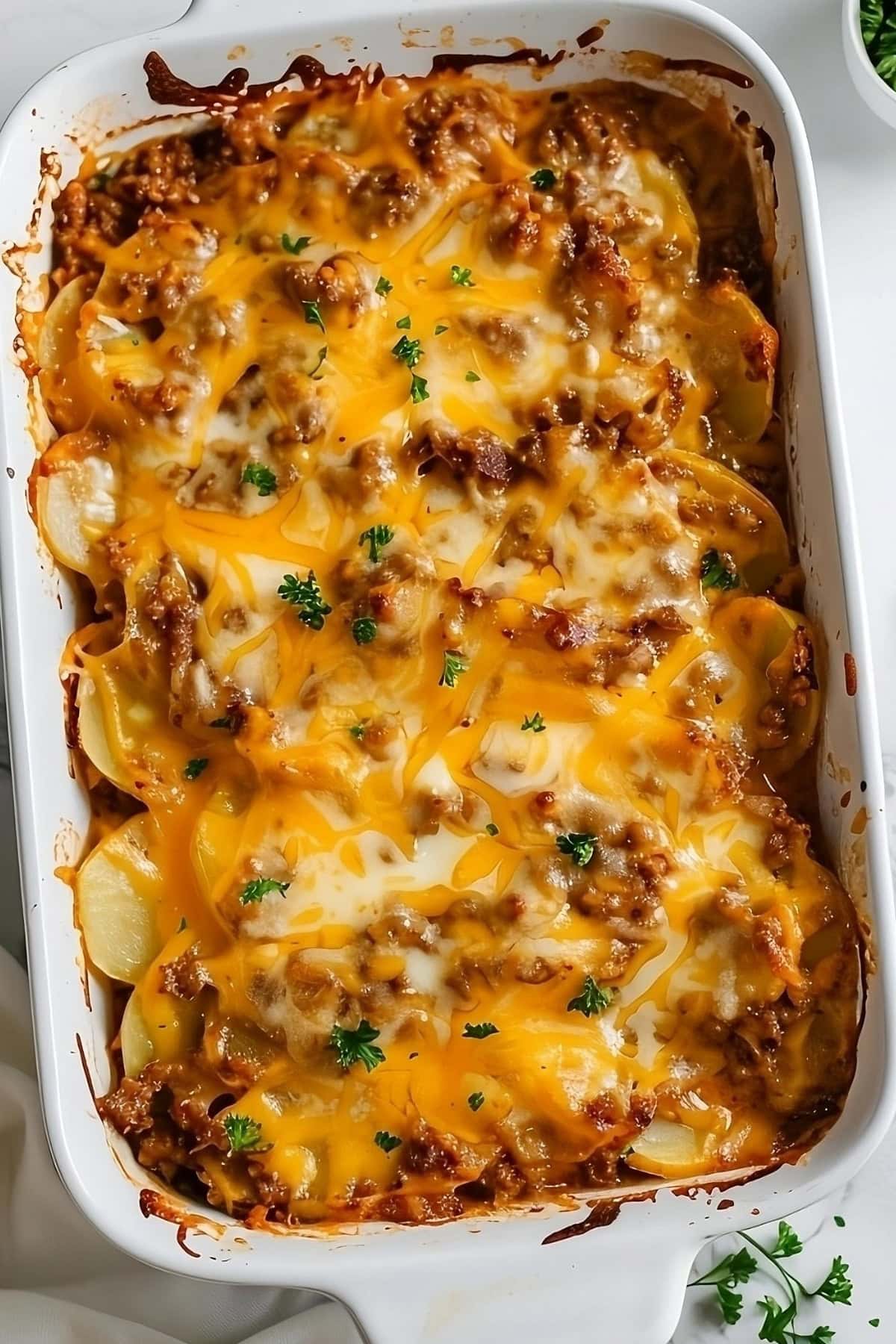 Whole sausage potato casserole in a baking dish.