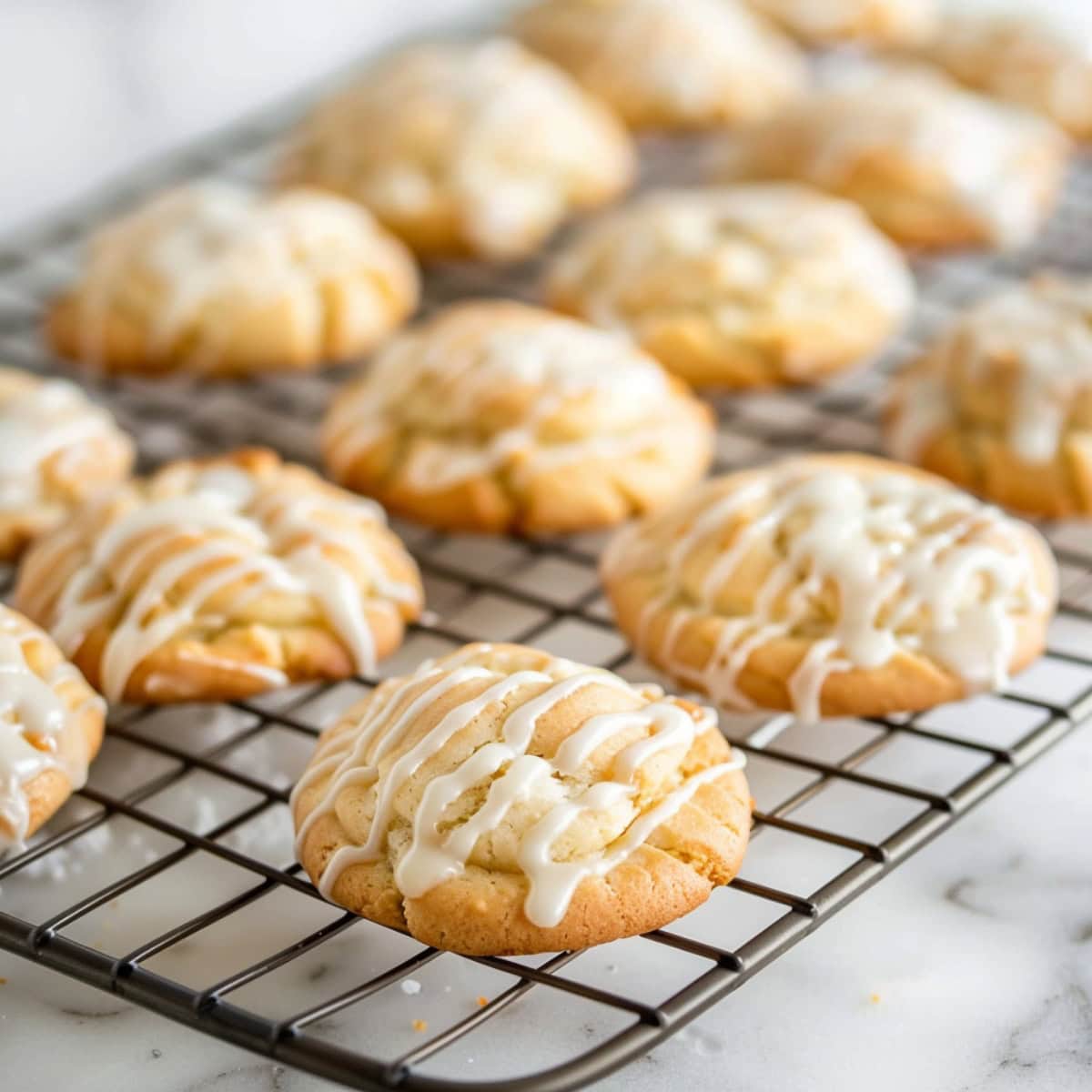 Buttermilk cookies on cooling rack with buttermilk glaze on top.