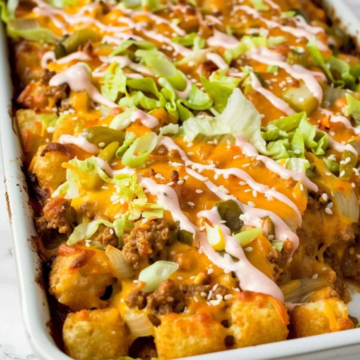 Closeup of Big Mac casserole in a white baking dish. 