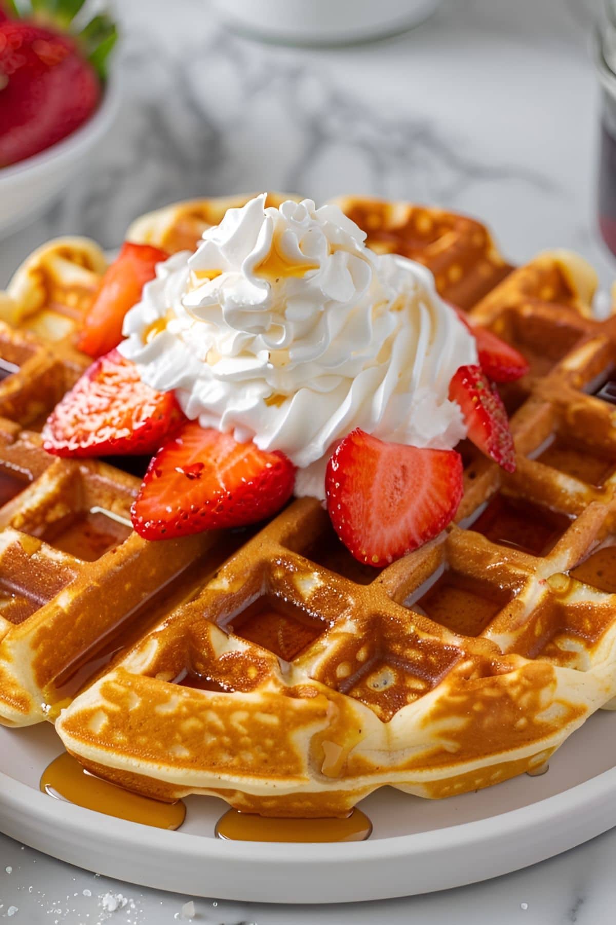 Bisquick Waffles Close-Up Photo with Whipped Cream, Maple Syrup, and Strawberries