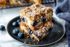 Moist blueberry coffee cake, topped with a crunchy streusel and drizzled with a sweet glaze.