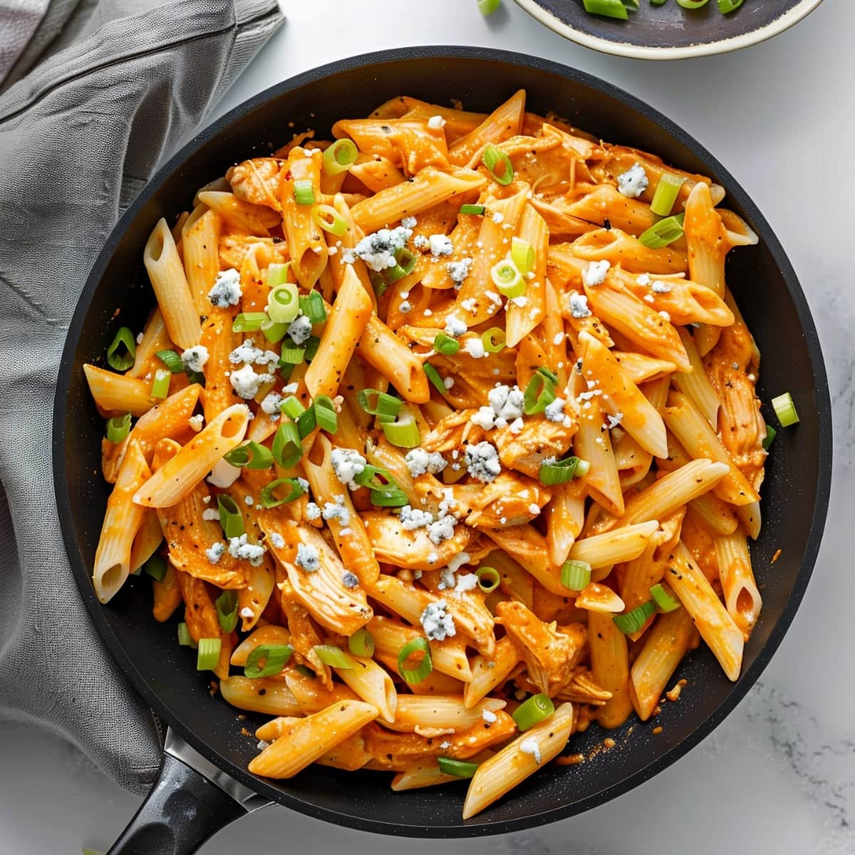 One-pot buffalo chicken pasta in a skillet with a delicious cream sauce