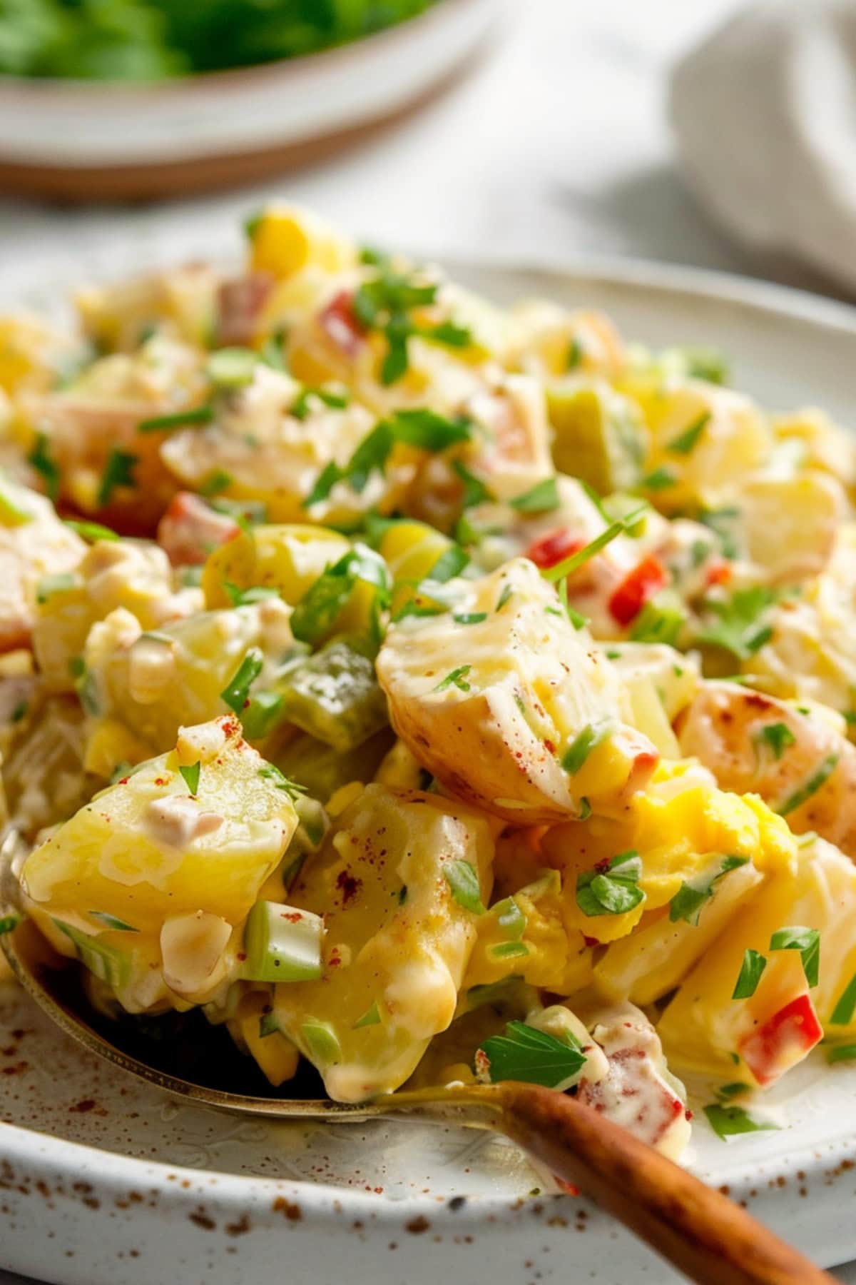 Cajun potato salad with spoon on a plate.