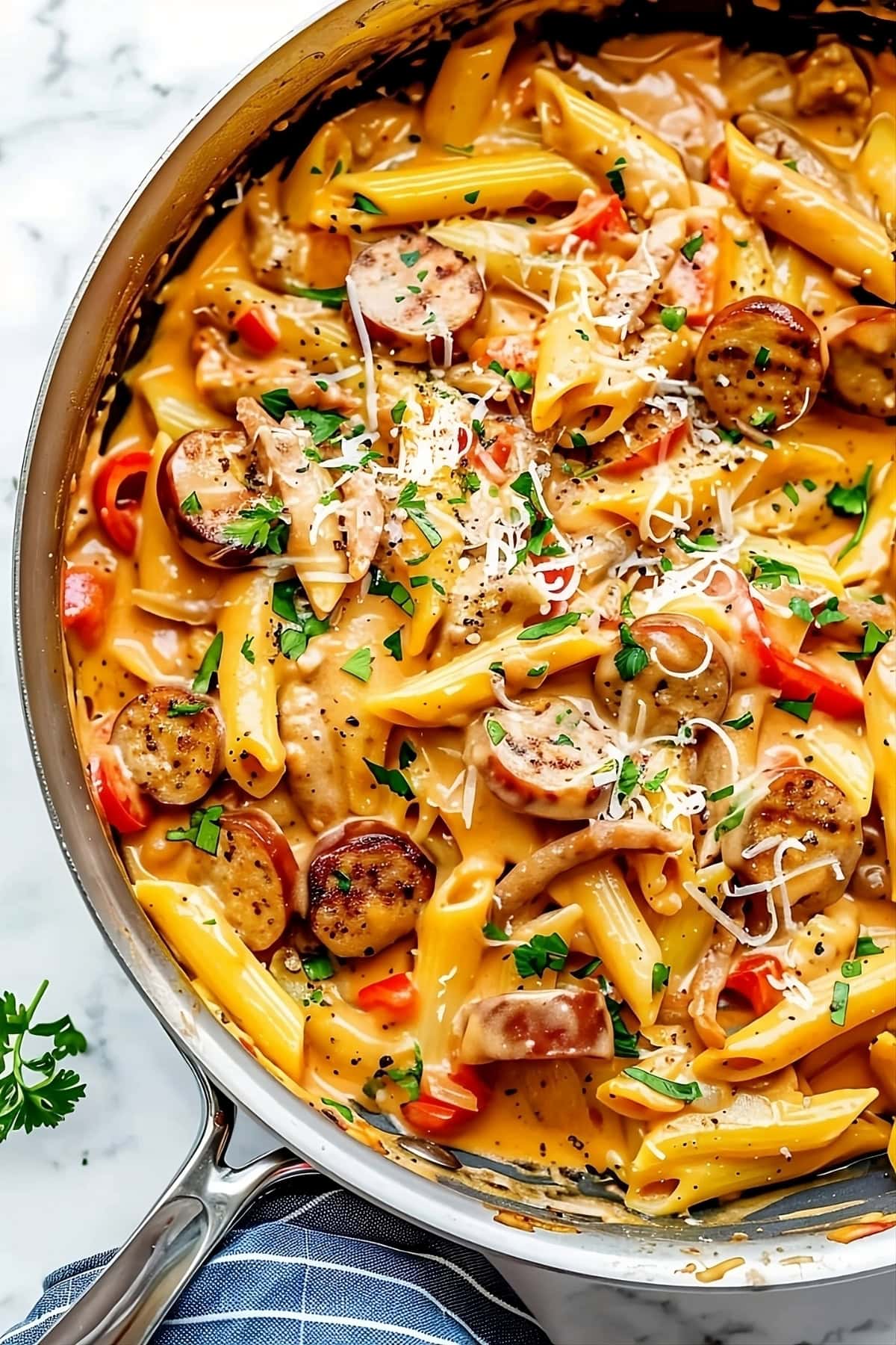 Cajun sausage pasta in a skillet pan with creamy cajun sauce.