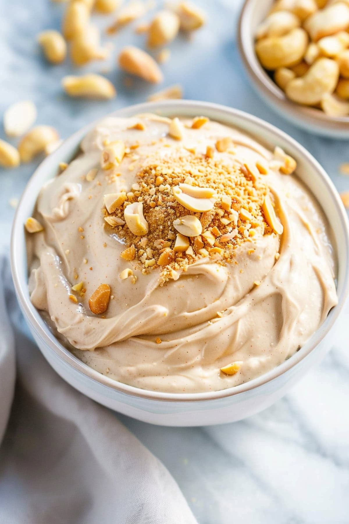 Creamy and fluffy peanut butter dip in a white bowl.