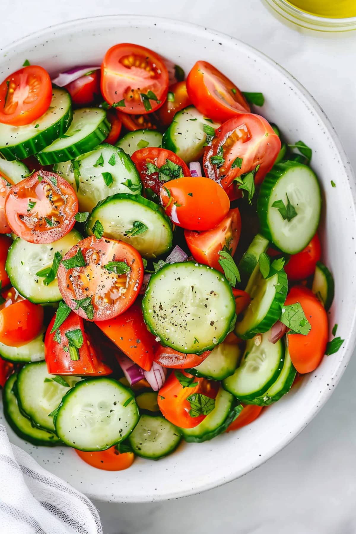 Appetizing homemade cucumber and tomato salad in a bowl.