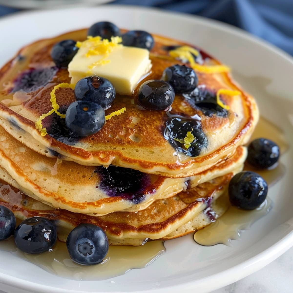 Irresistible lemon blueberry pancakes, featuring a zesty lemon flavor and bursting with juicy blueberries.