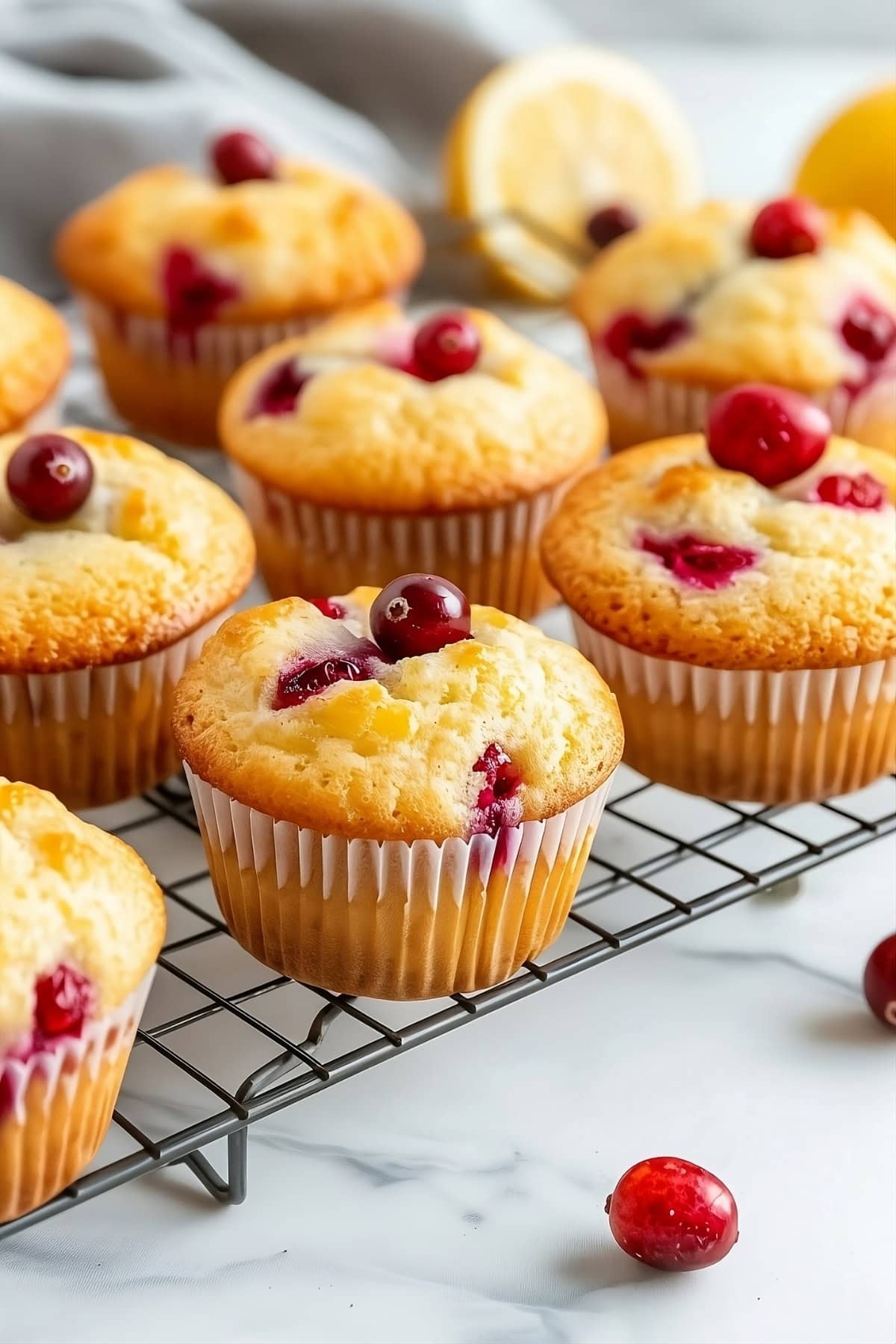 Lemon cranberry muffins arranged in a cooling rack.