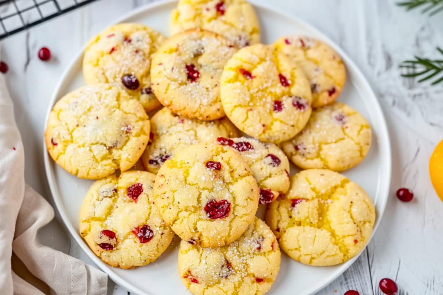 Bunch of orange cranberry cookies served in a white round plate.