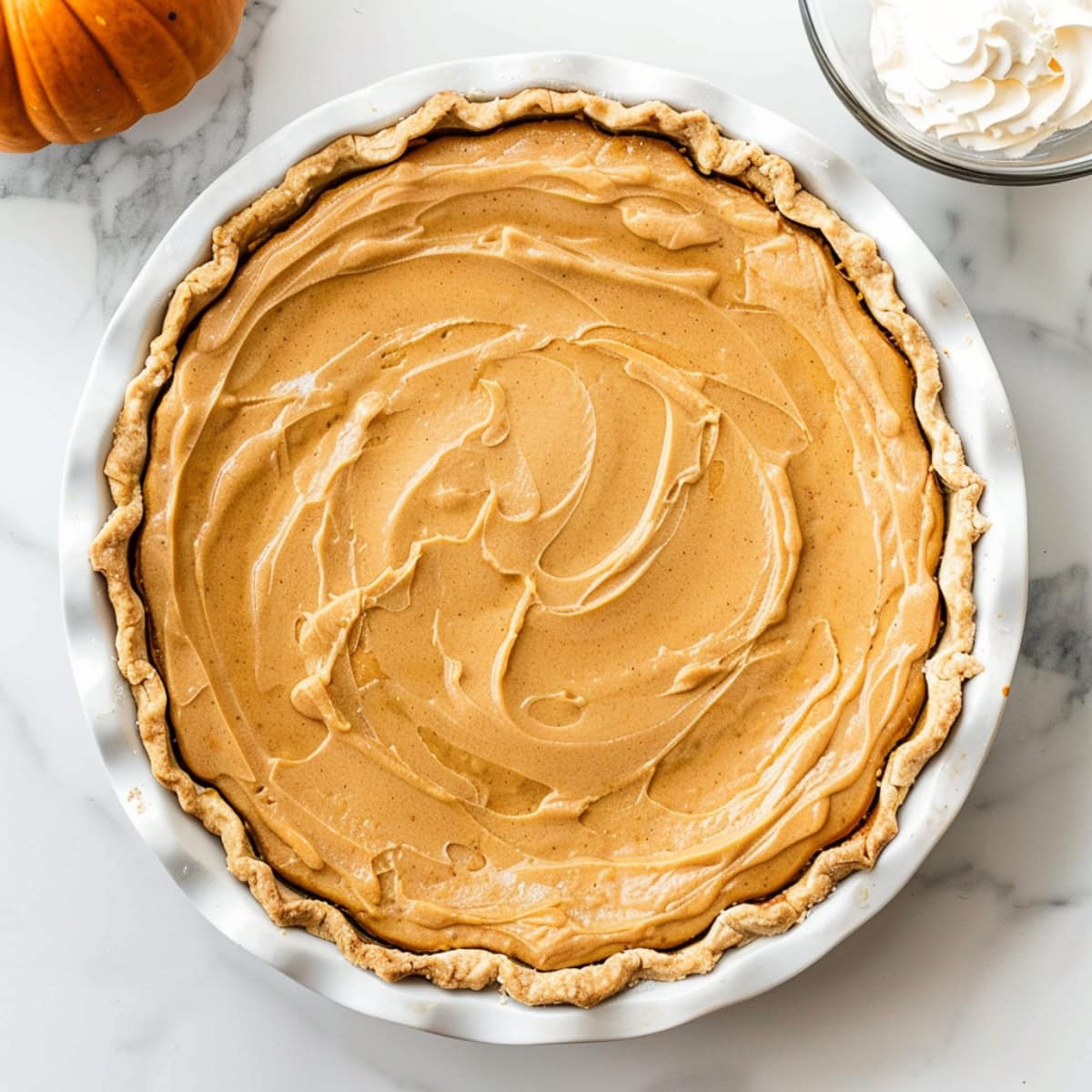 Whole pumpkin cream pie in a pie dish.