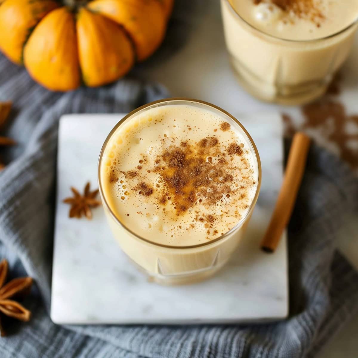 Rich and creamy homemade pumpkin eggnog in a glass