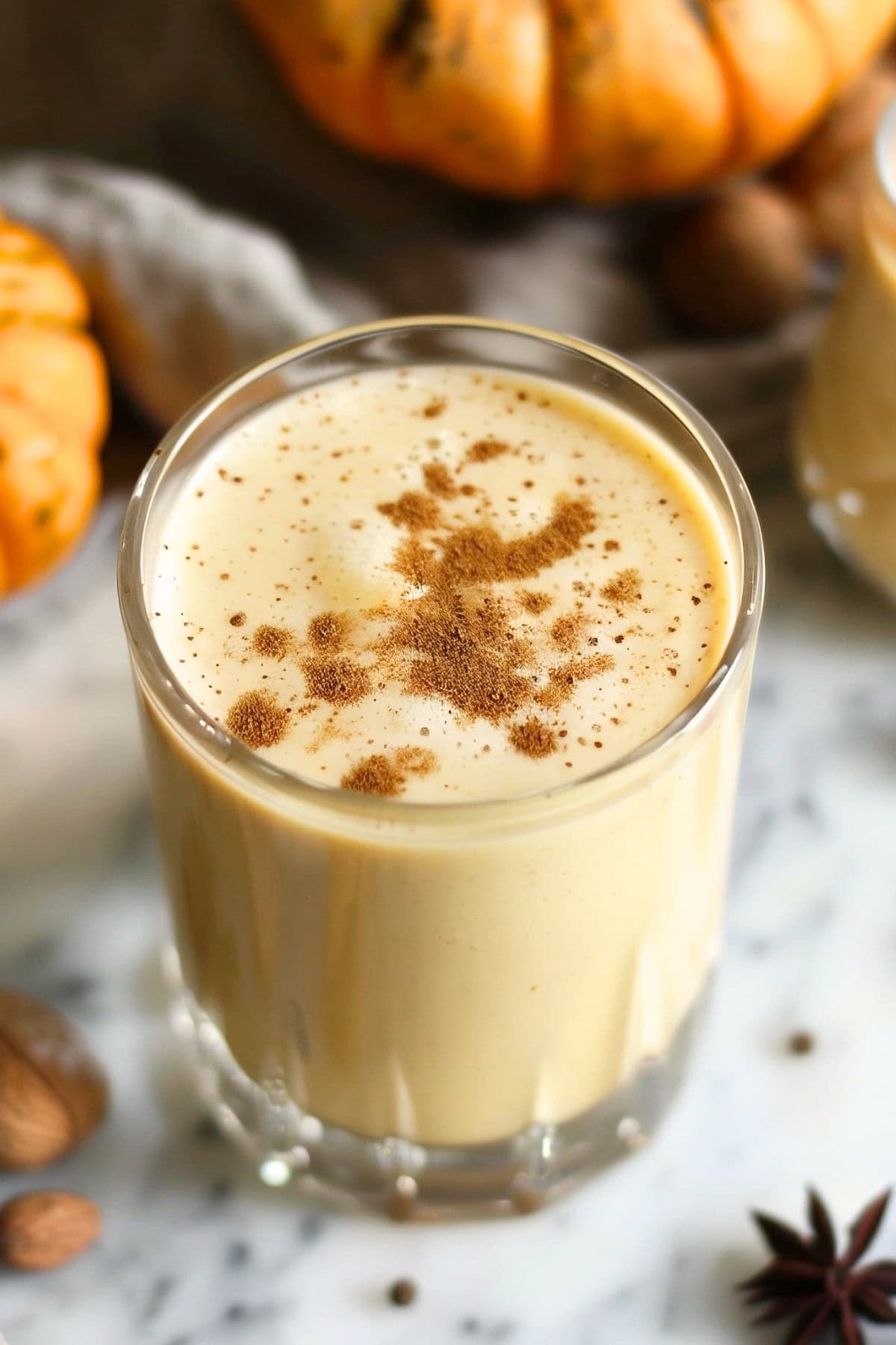 Pumpkin eggnog in a glass, sprinkled with grated nutmeg