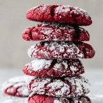 Stack of Red Velvet Crinkle Cookies Dusted with Powdered Sugar