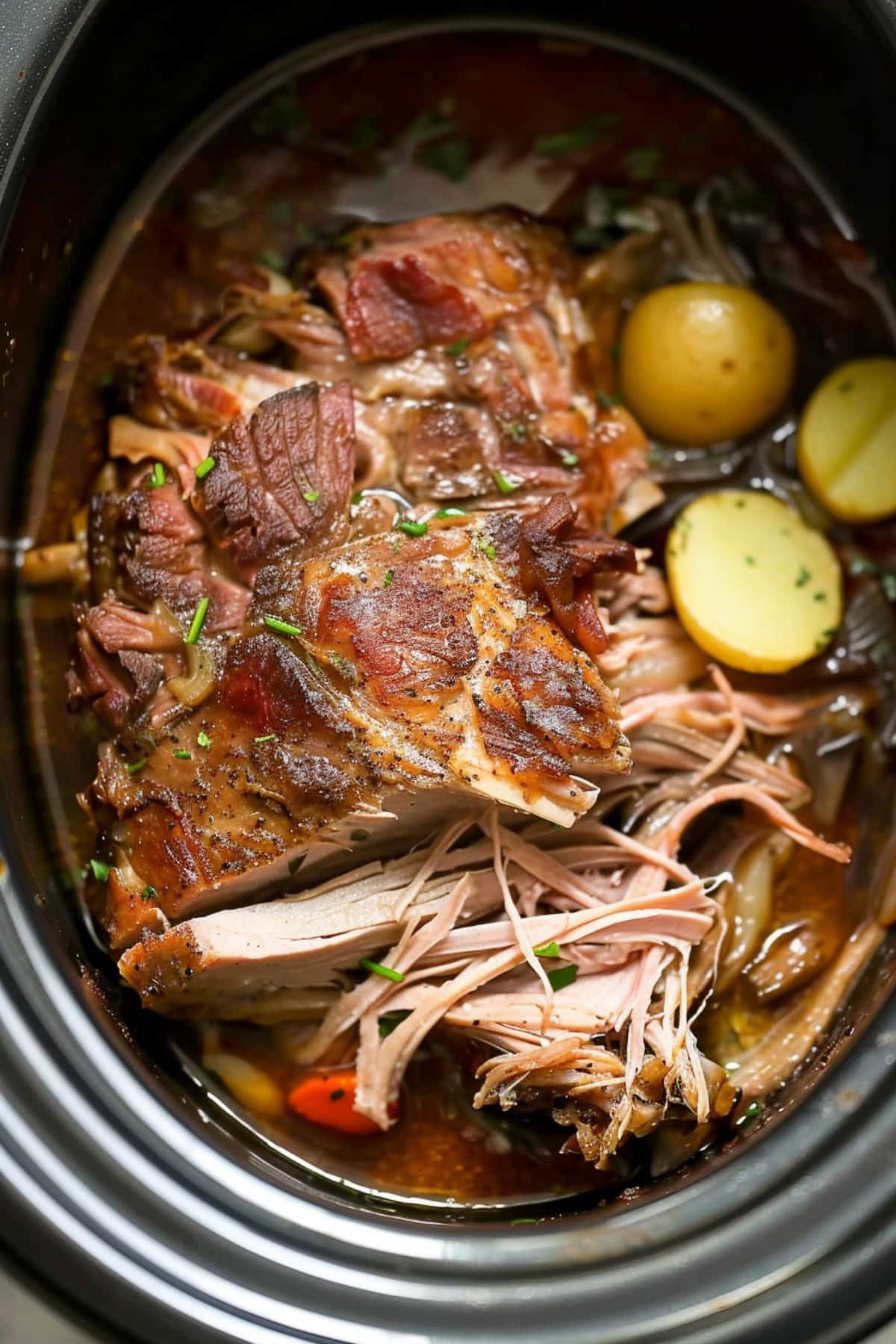 Shredded roast pork in slow cooker.