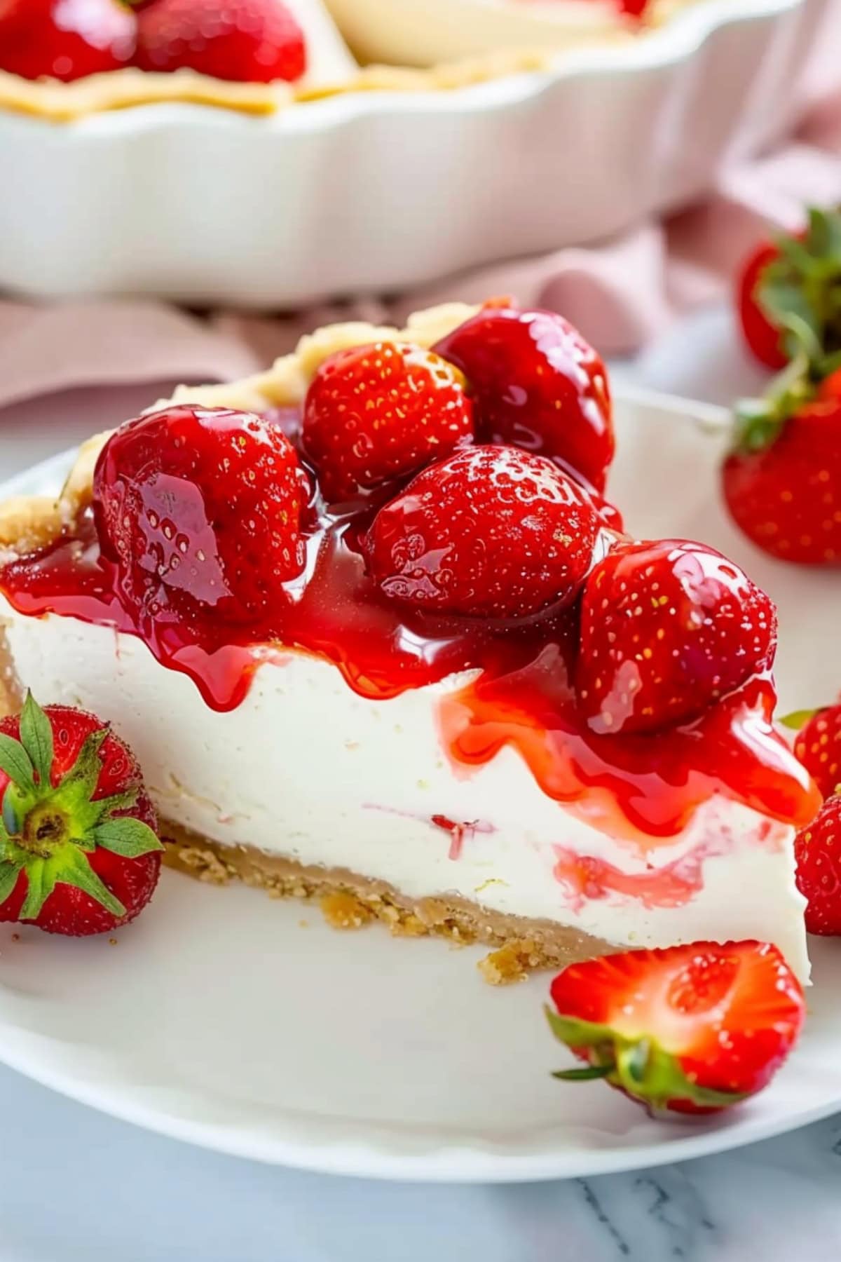 Slice of strawberry cream pie on a white plate.