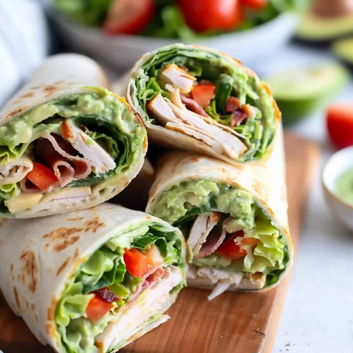 Turkey avocado wraps in a wooden board.