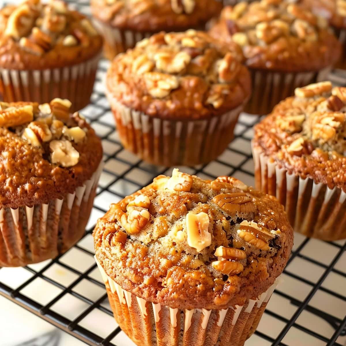 Banana Oat Muffins in Muffin Liners on a Cooling Rack