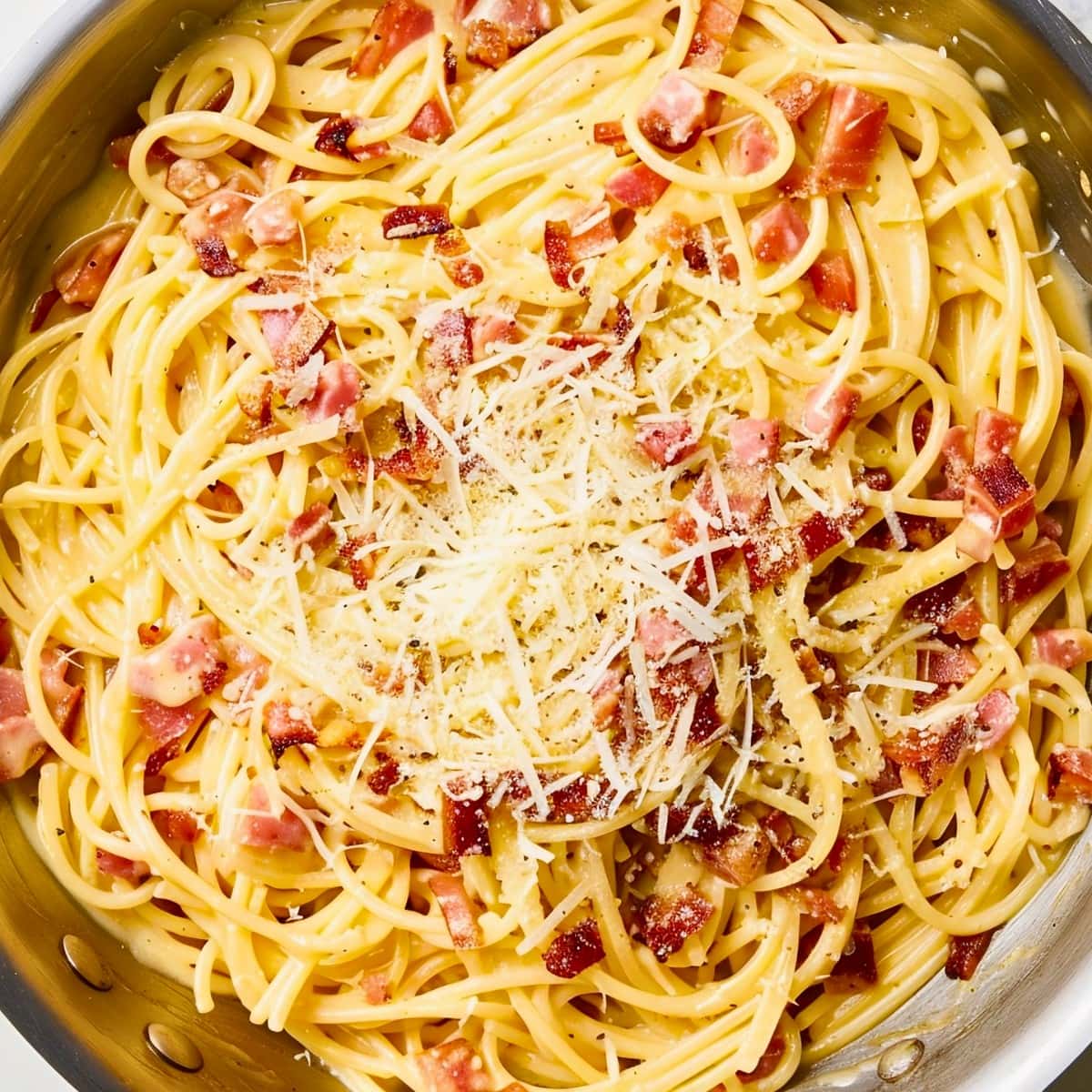 Top View of Fresh Pasta Carbonara in a Frying Pan with Bacon, Spaghetti Noodles, and Parmesan Cheese