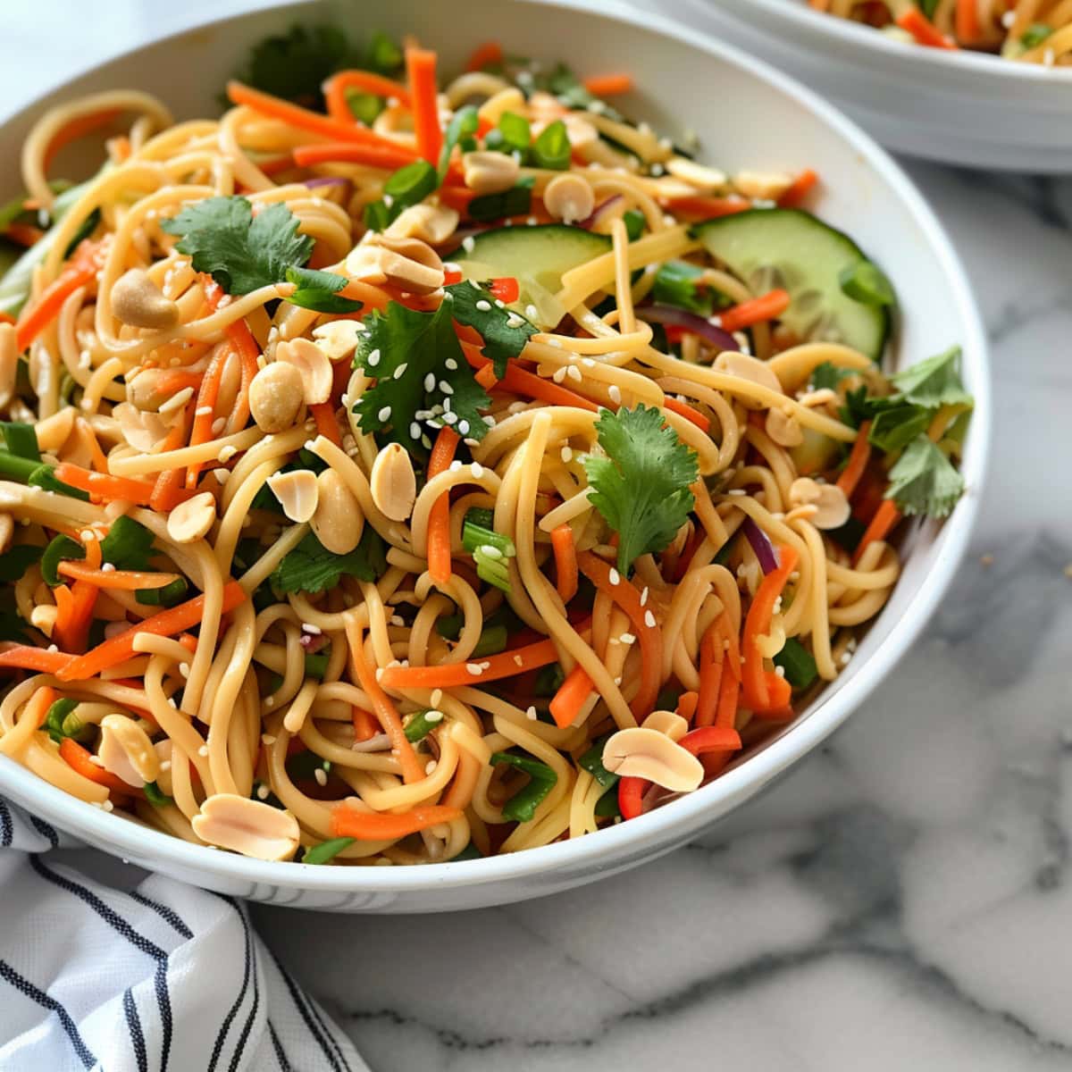 Light Asian noodle salad served with fresh herbs, crunchy vegetables, and a peanut butter dressing.
