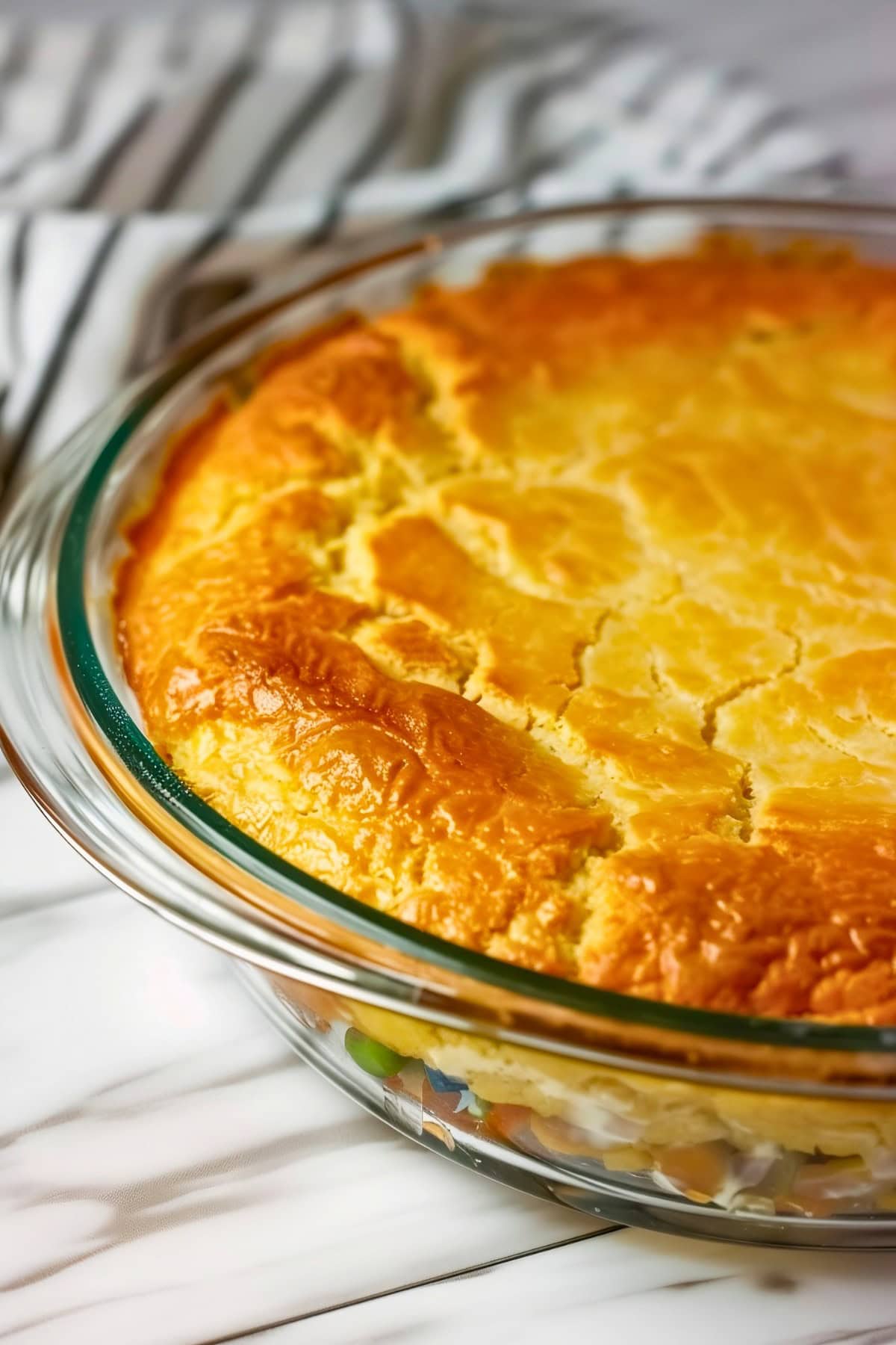 Close Up View of Baked Bisquick Chicken Pot Pie in Pie Dish with Flaky, Golden Crust