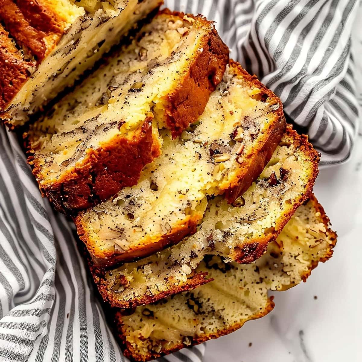 Top Close View of Slices of Slices of Cake Mix Banana Bread on a White Marble Table