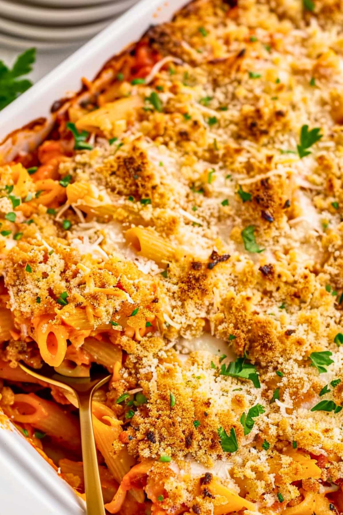 Top view of chicken parmesan casserole in a white baking dish.