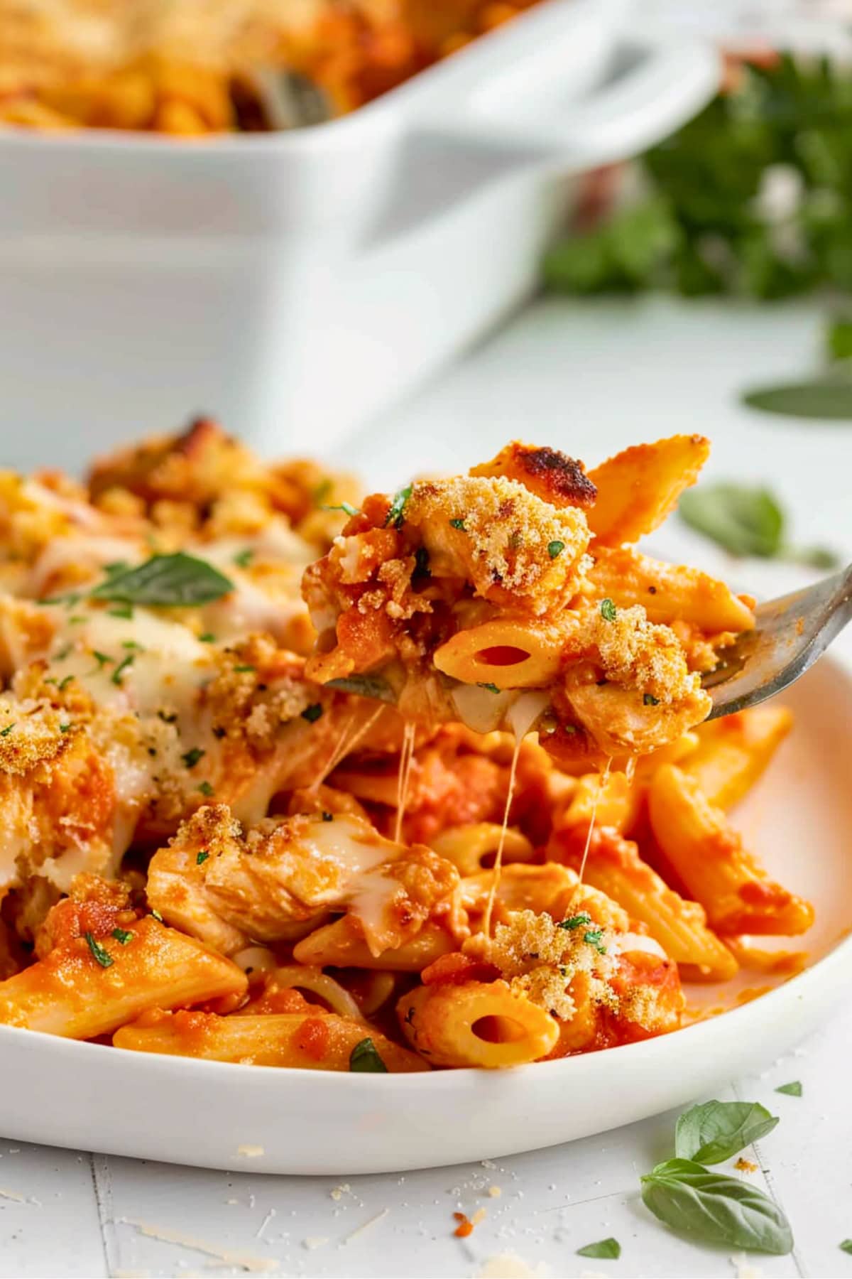 Cheesy chicken parmesan casserole in a plate with fork.