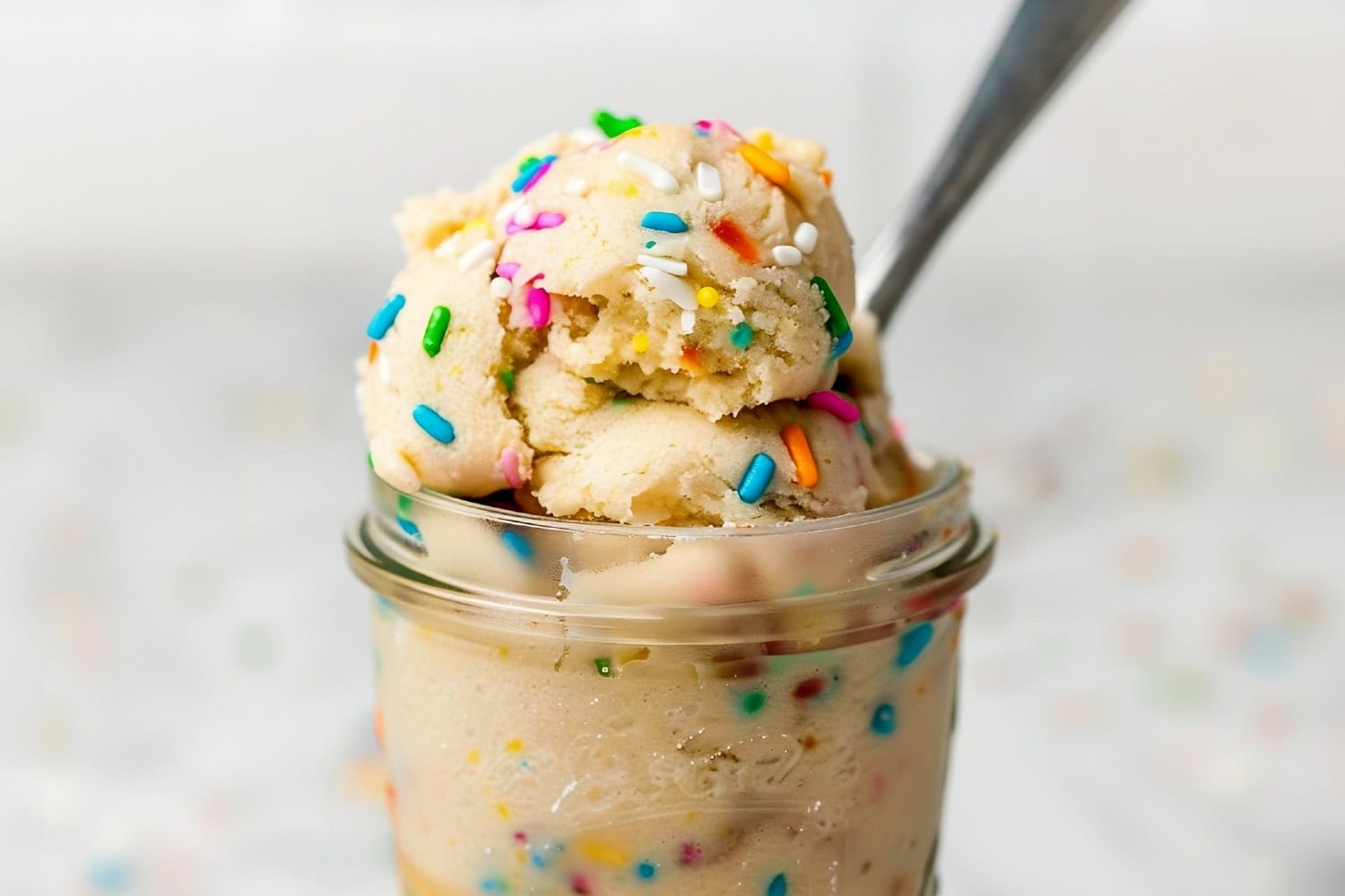 Smooth and delicious edible sugar cookie dough, ready to eat with a spoon.