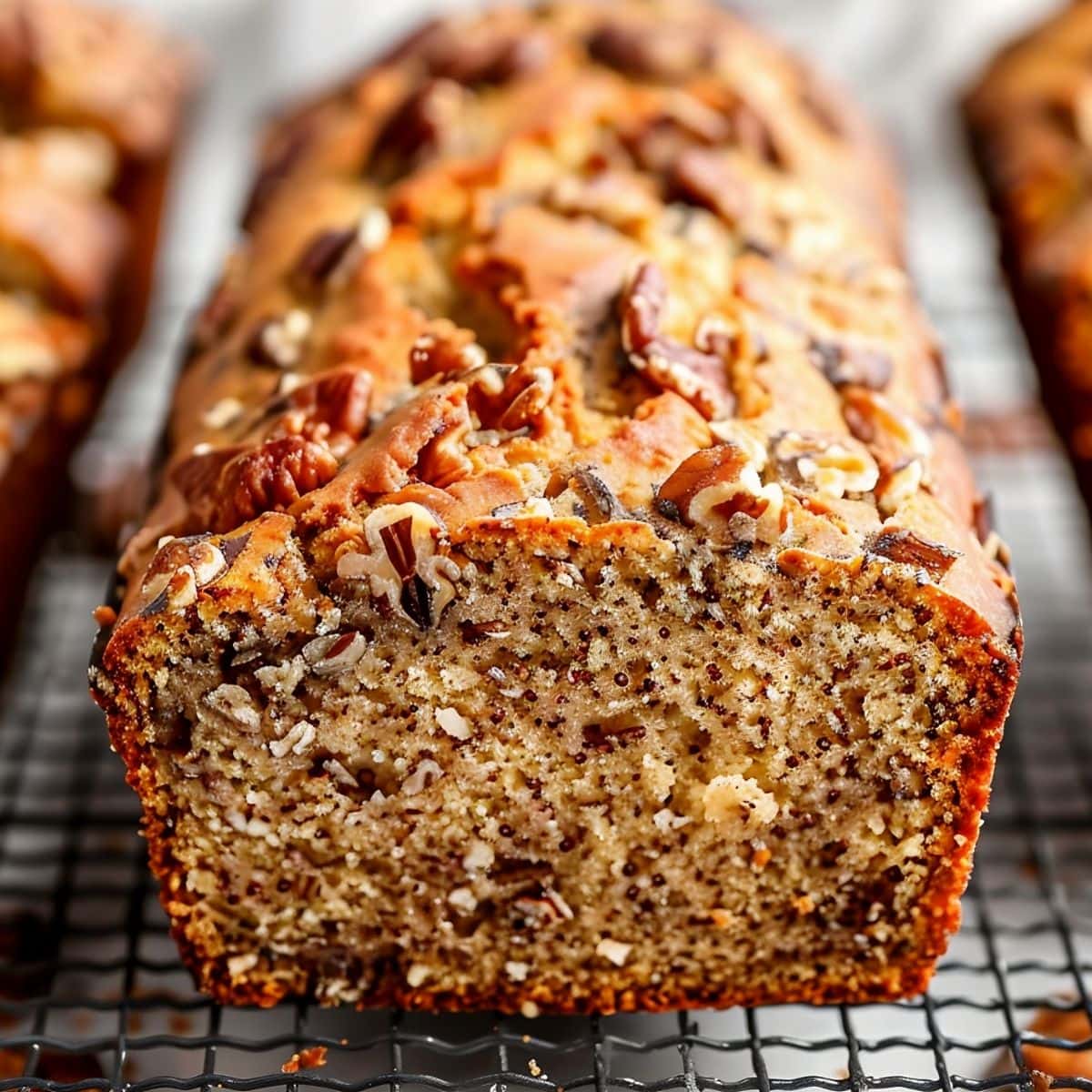 Close Up of Ina Garten's Banana Bread Loaf with Pecans Cooling on a Wire Rack