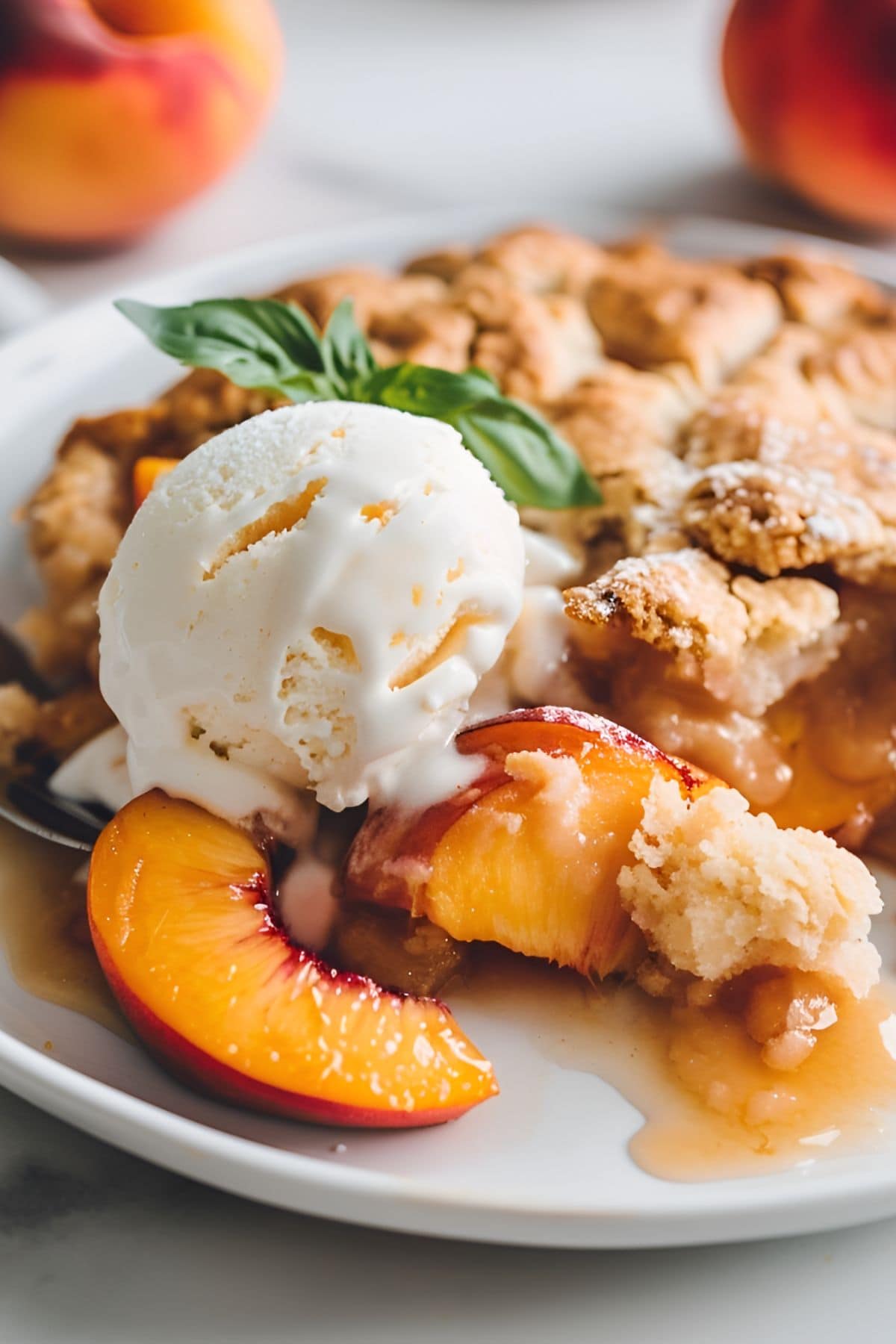 Close Up of Patti Labelle's Peach Cobbler on a Plate with Vanilla Ice Cream and Mint