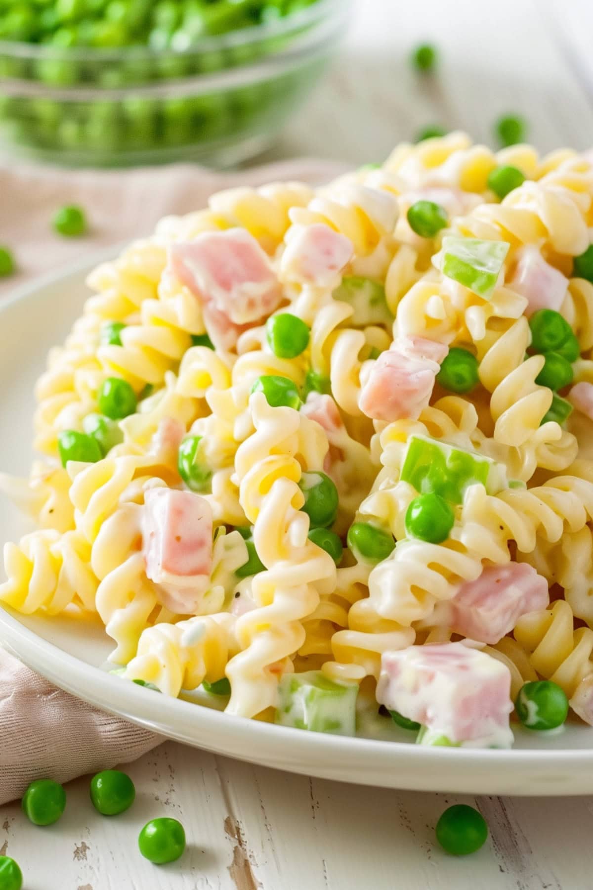 Plate of salad and bowl of green peas.