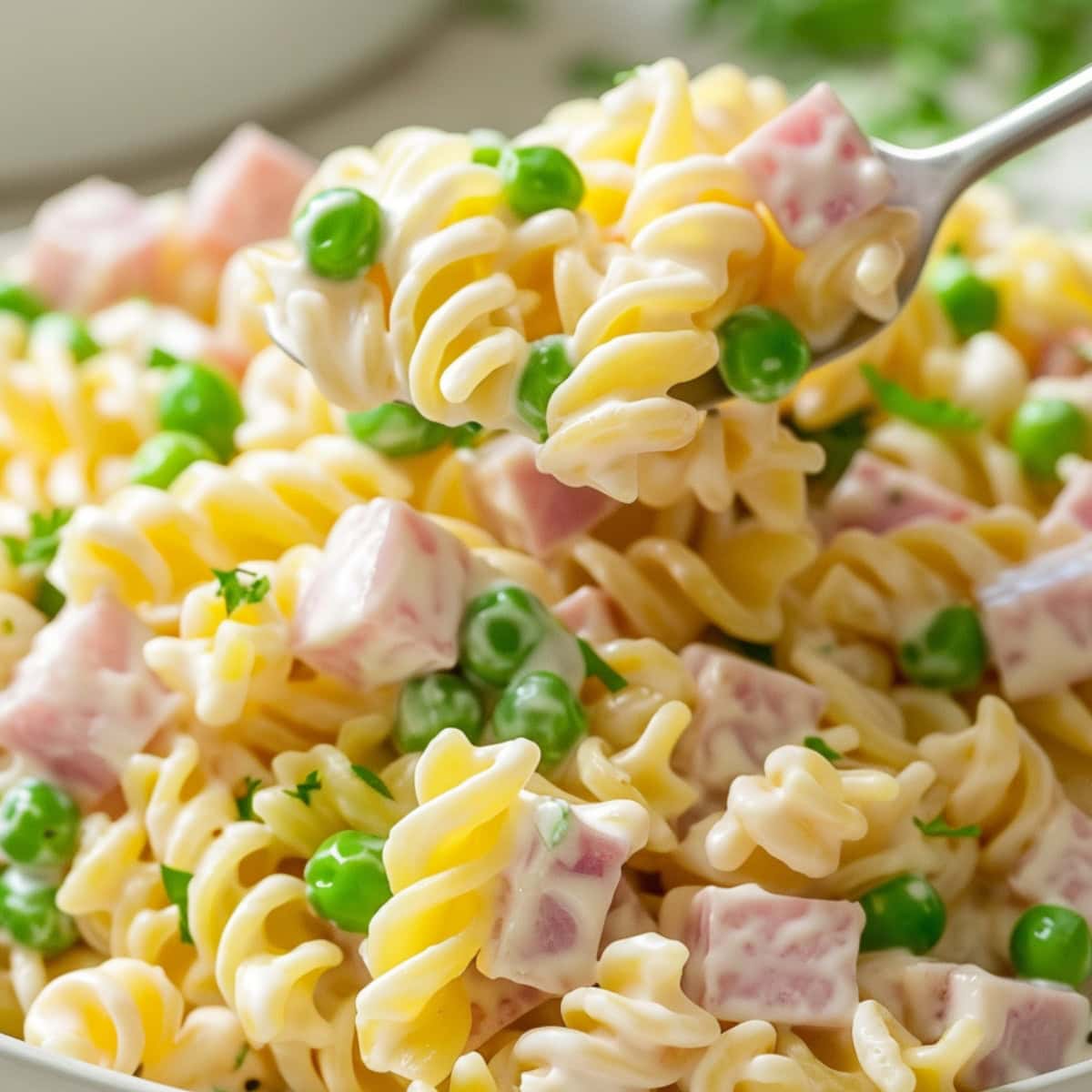 Pork scooping in a bowl of ruby Tuesday pasta salad.