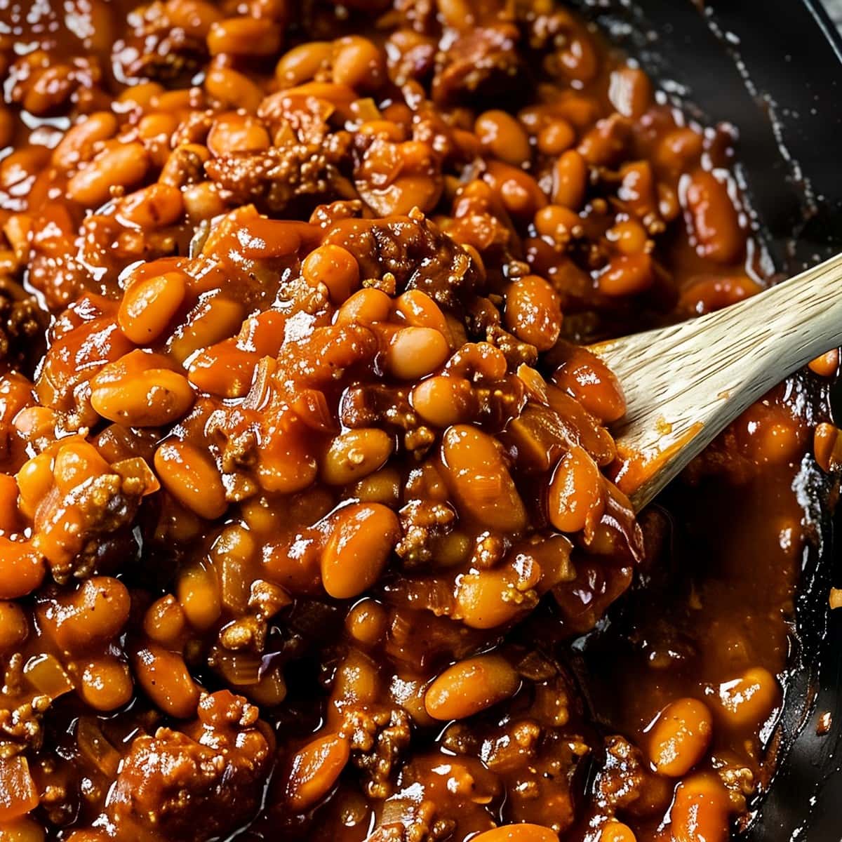 Super Close Up of BBQ Baked Beans in a Skillet with Ground Beef, Sauce, Onions, and Beans