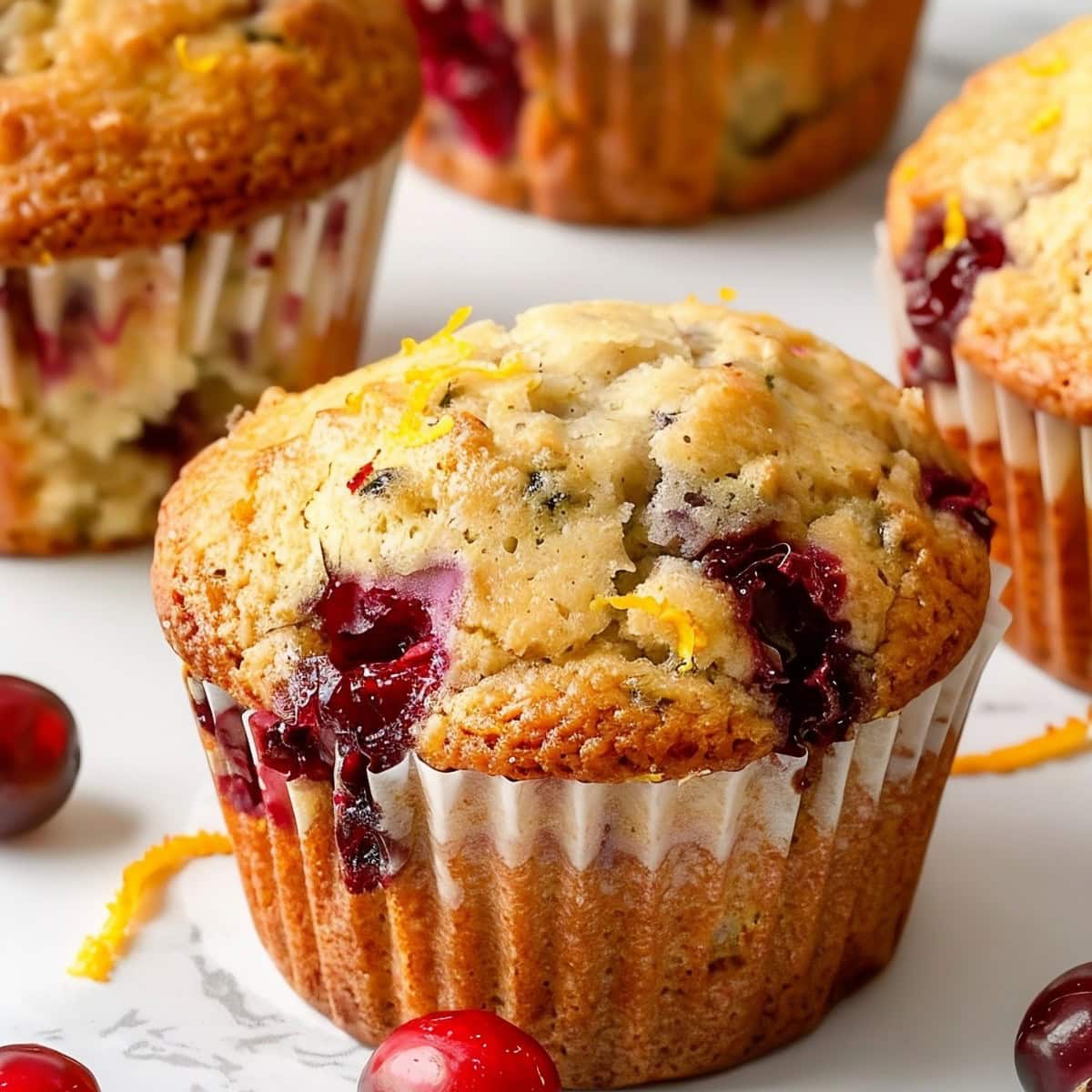 Close Up of Cranberry Orange Muffins with Delicious Burst Cranberries and Orange Zest