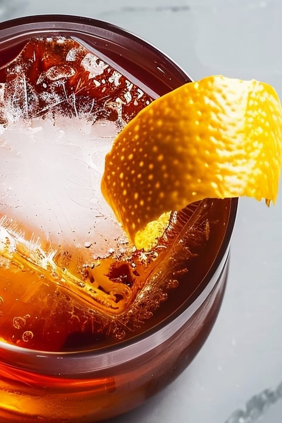 Super Close Up Top View of Mezcal Negroni in Rocks Glass with Ice and Orange Peel