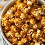 Top View of Microwave Caramel Popcorn in a Bowl with a Kitchen Towel