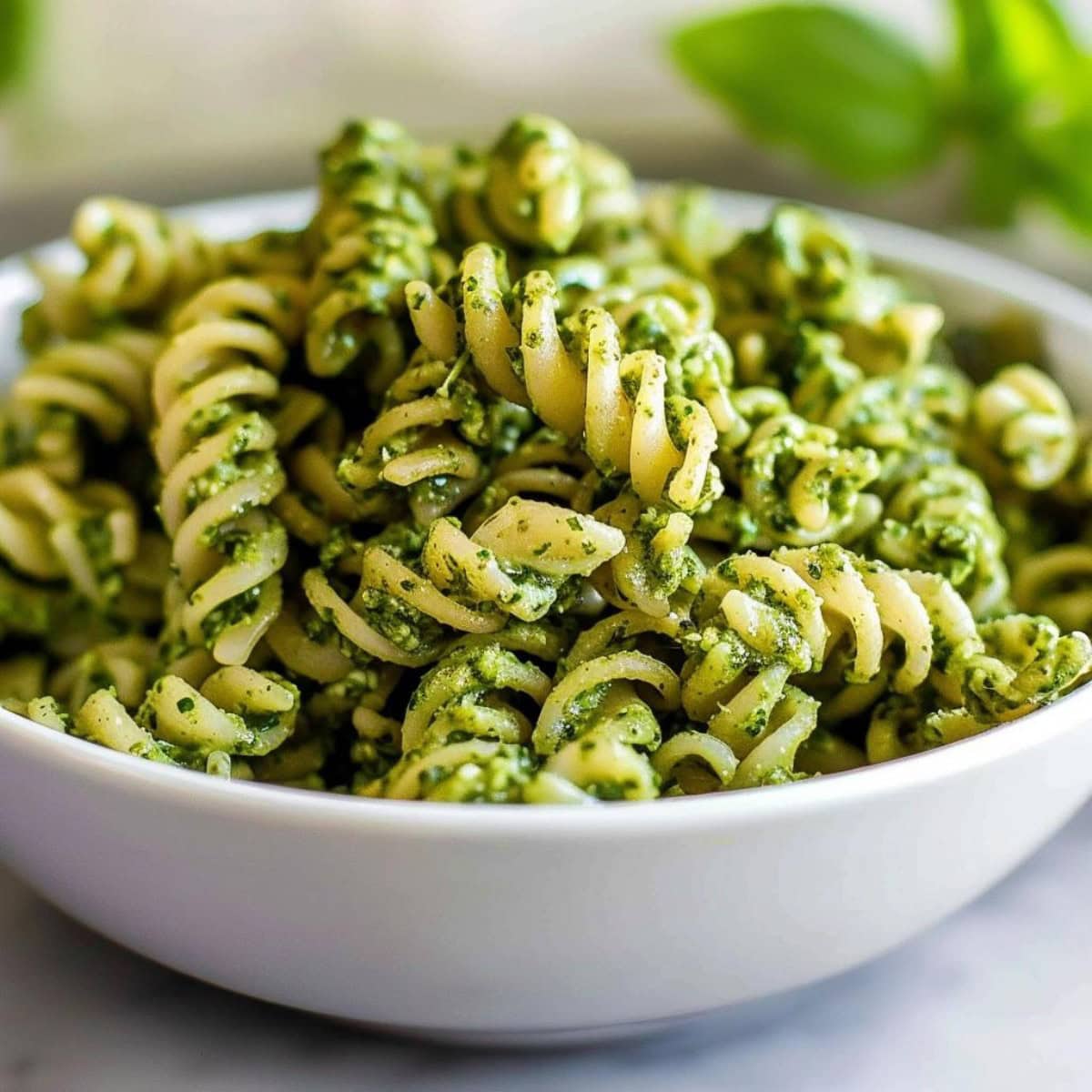 Close up of Delicious Pesto Pasta in a White Bowl 