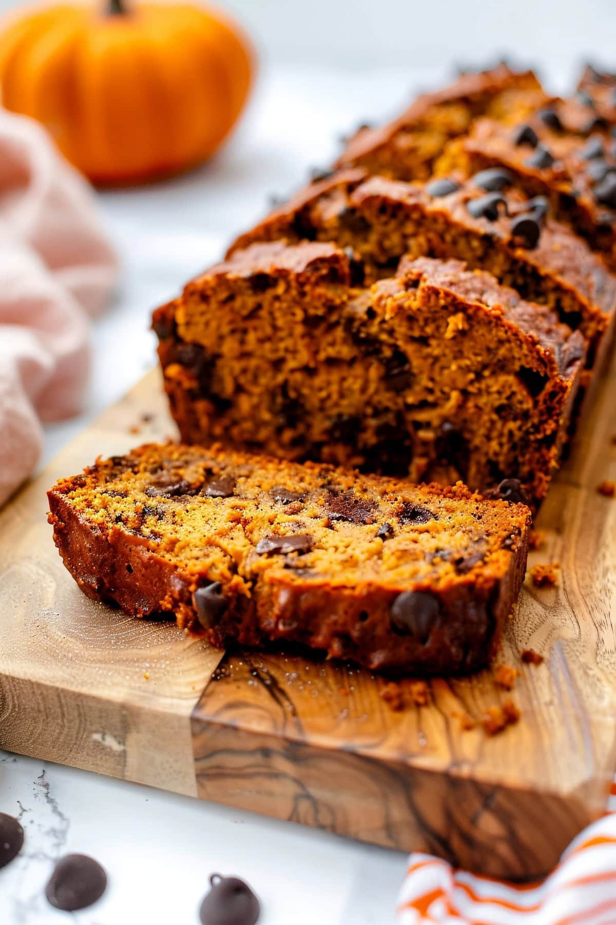 Close up Pumpkin Chocolate Chip Bread Slices on a Wooden Cutting Board