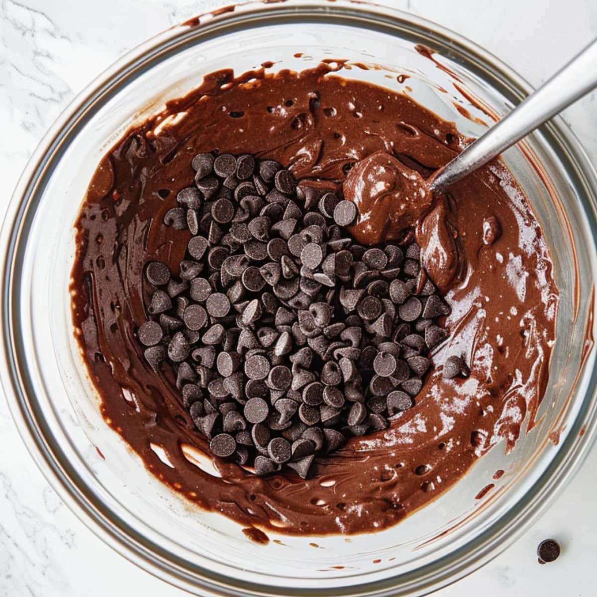 Top View of Too Much Chocolate Cake Batter with Chocolate Chips in a Glass Bowl 