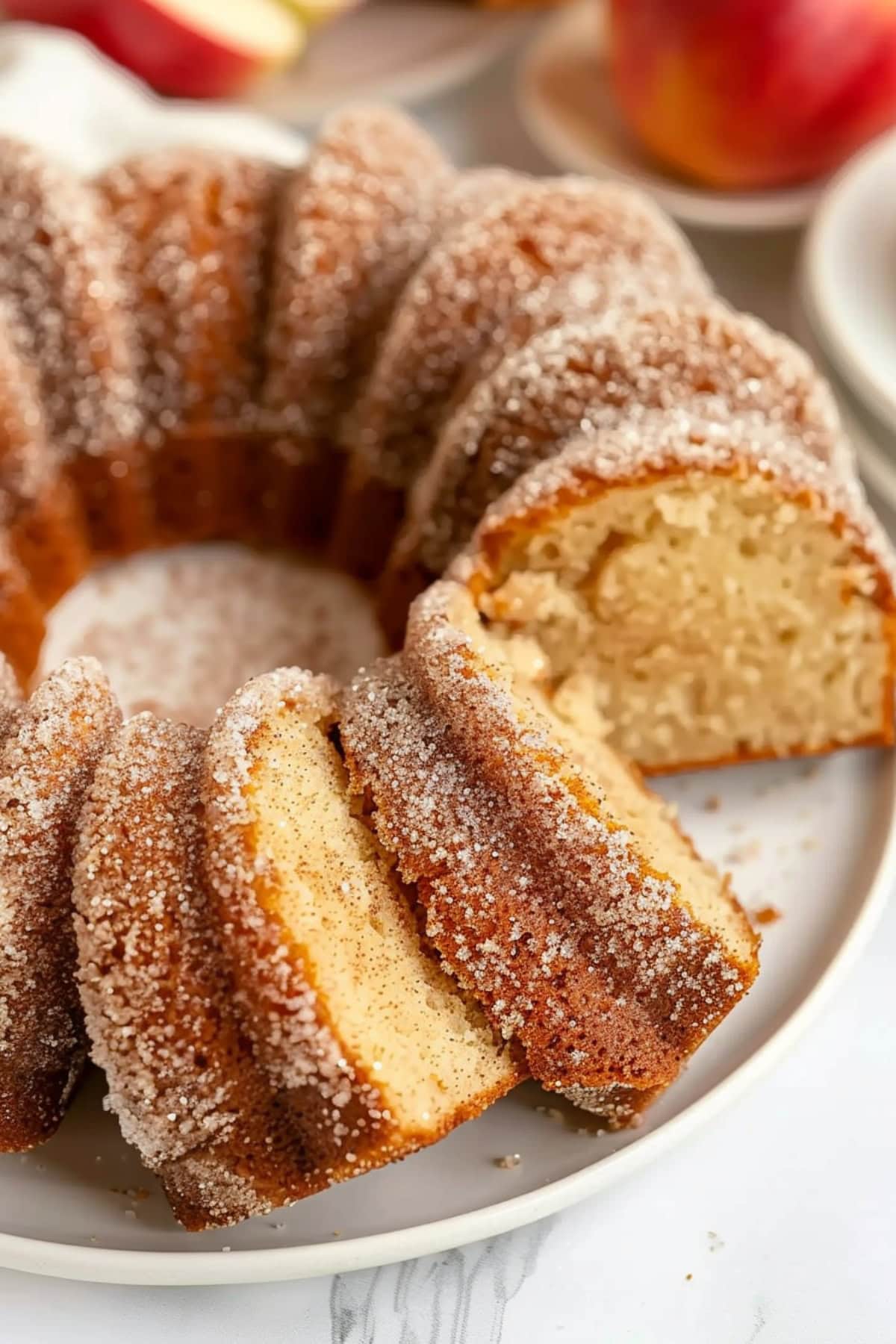 Sliced apple cider donut bundt cake served in a white plate. 