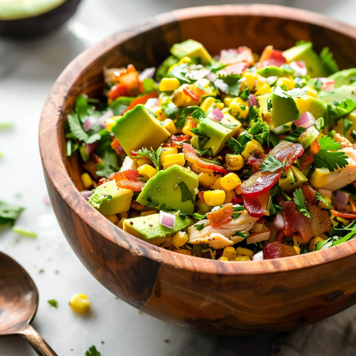 Avocado chicken salad in a wooden bowl.