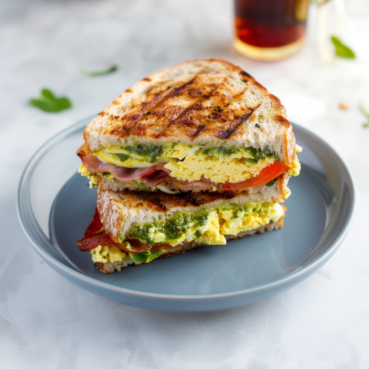 Warm Breakfast Panini Filled With Eggs, Tomatoes, Crispy Bacon and Spinach.