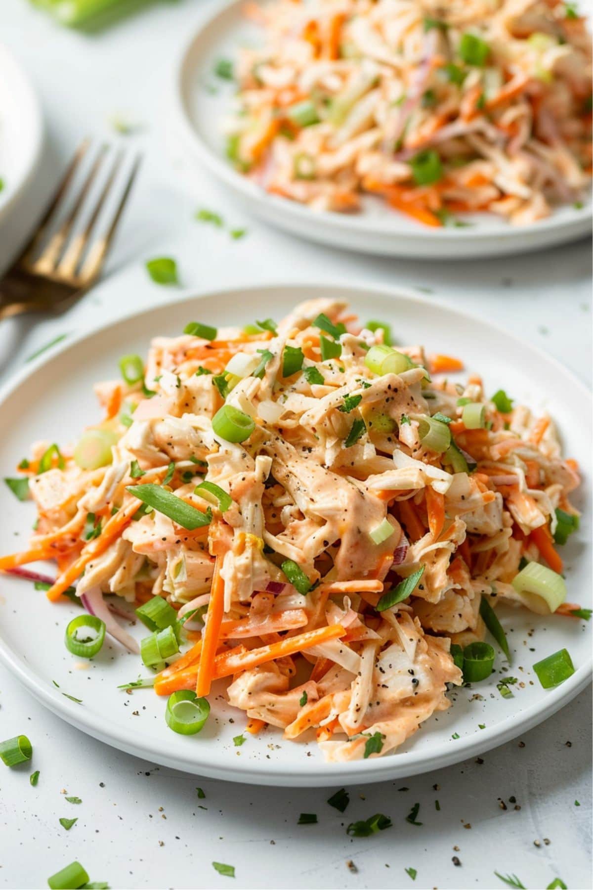 Two servings of buffalo chicken salad on a white plate.