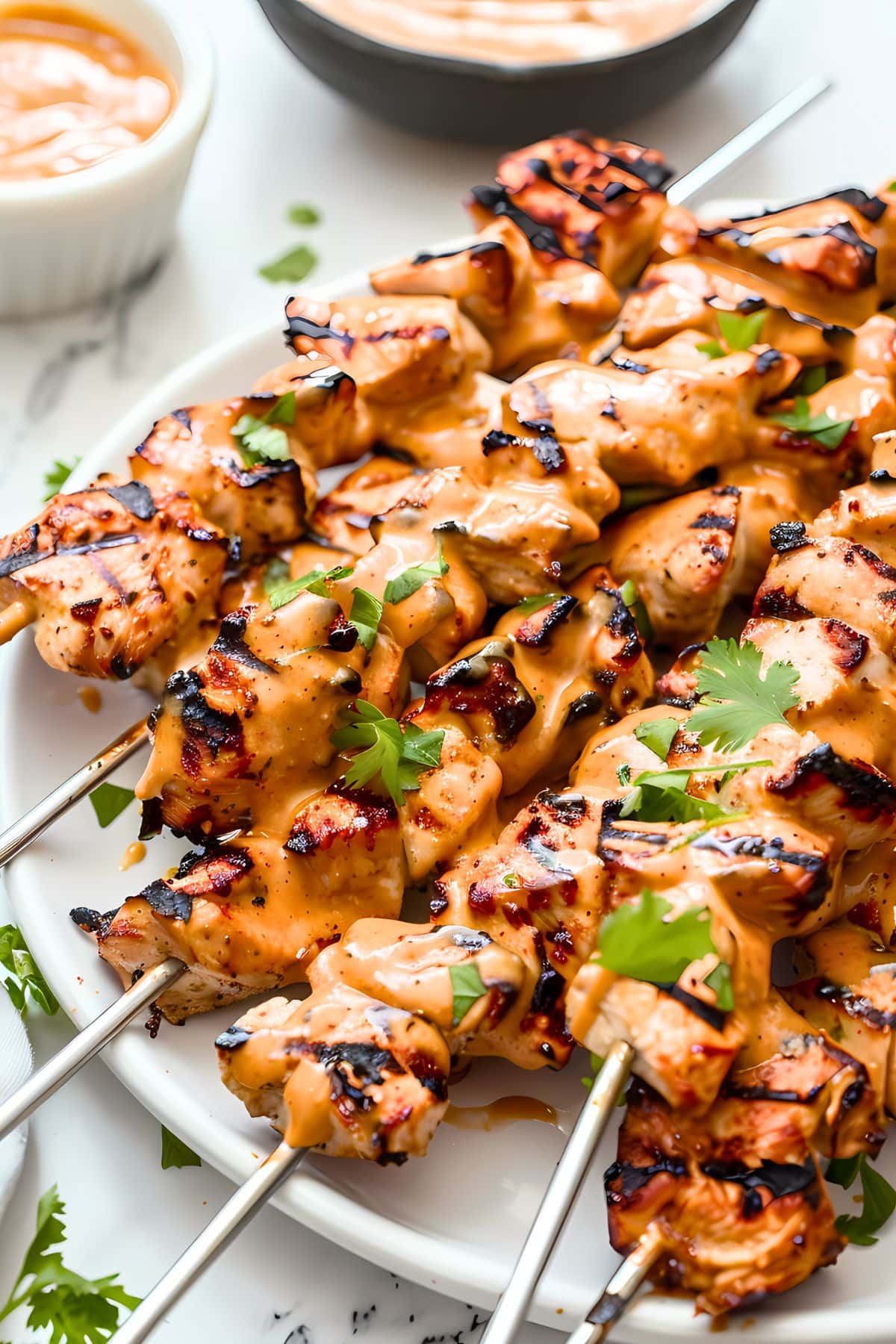 Chicken satay skewers drizzled with Thai peanut butter sauce