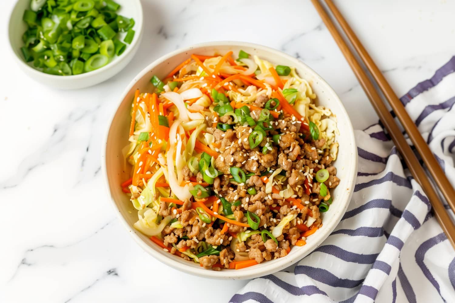 Homemade egg roll in a bowl with ground beef and vegetables.